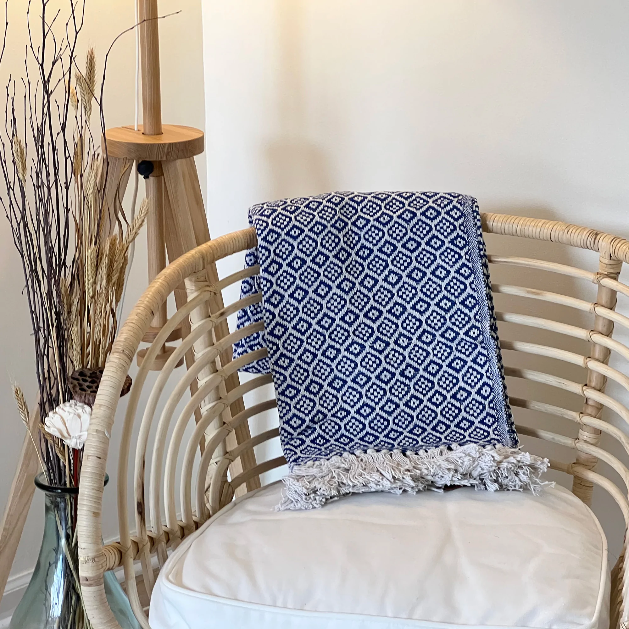 Beautifully woven throw made from partially recycled cotton. Hand made in India with tradition Partially recycled cotton throw in indigo blue with diamond batik design